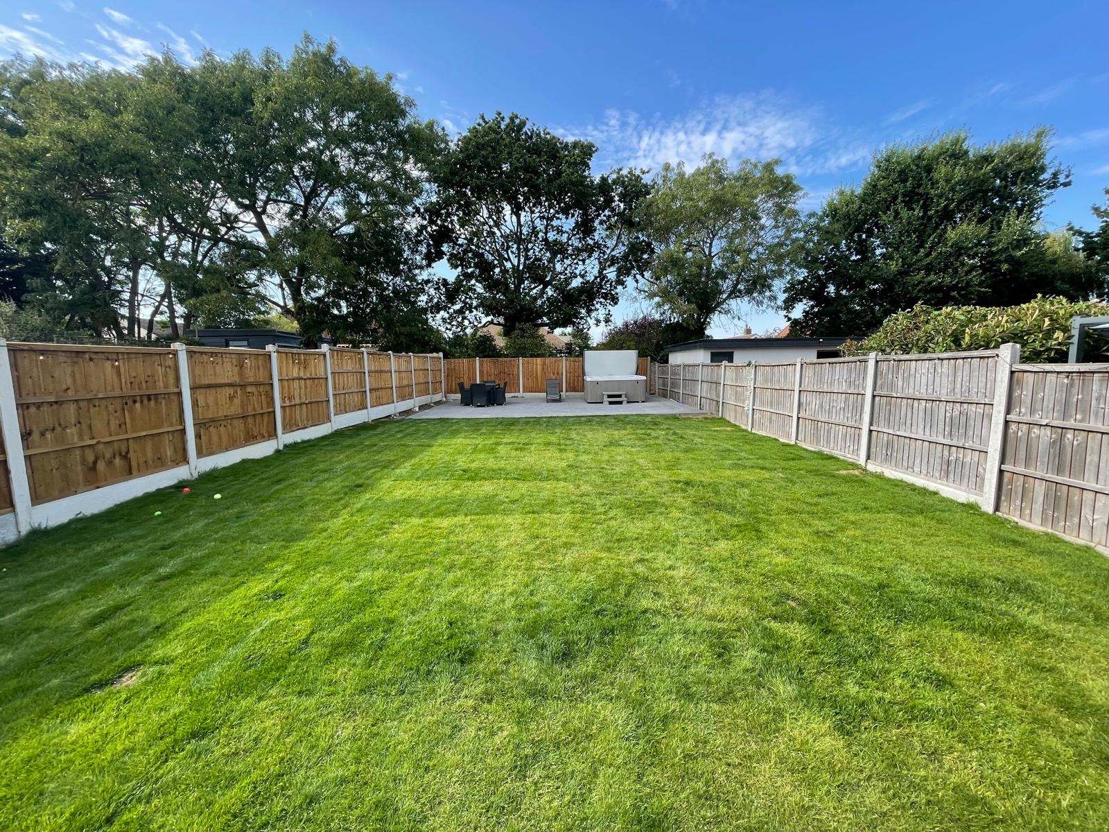 Finished landscaped garden with lawn and seating area