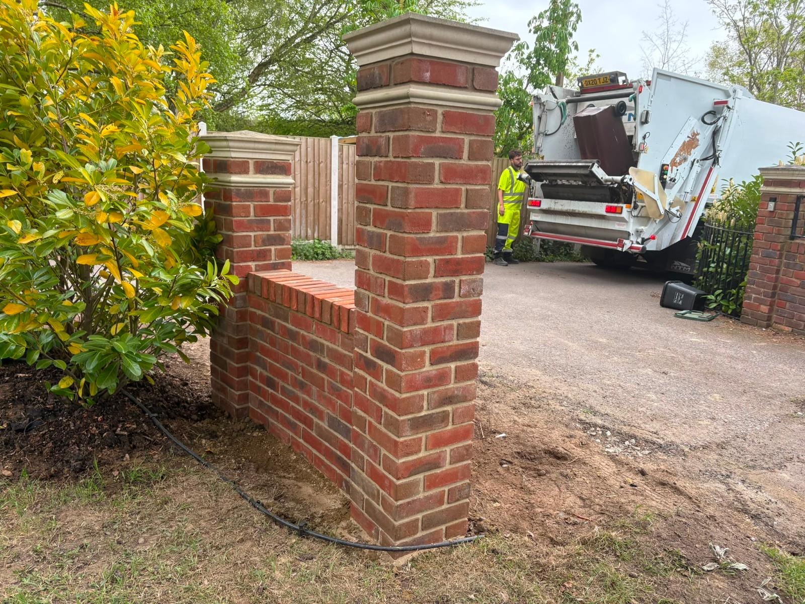 New brick garden wall and capped entrance piers