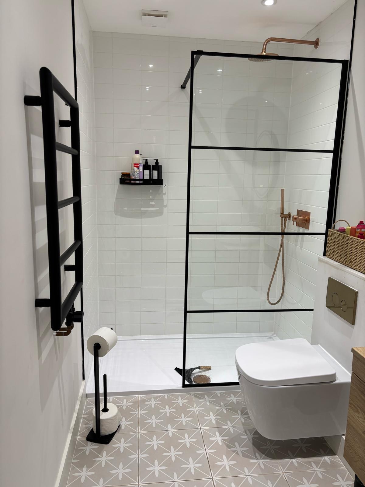 Finished bathroom with walk-in shower and patterned floor tiles
