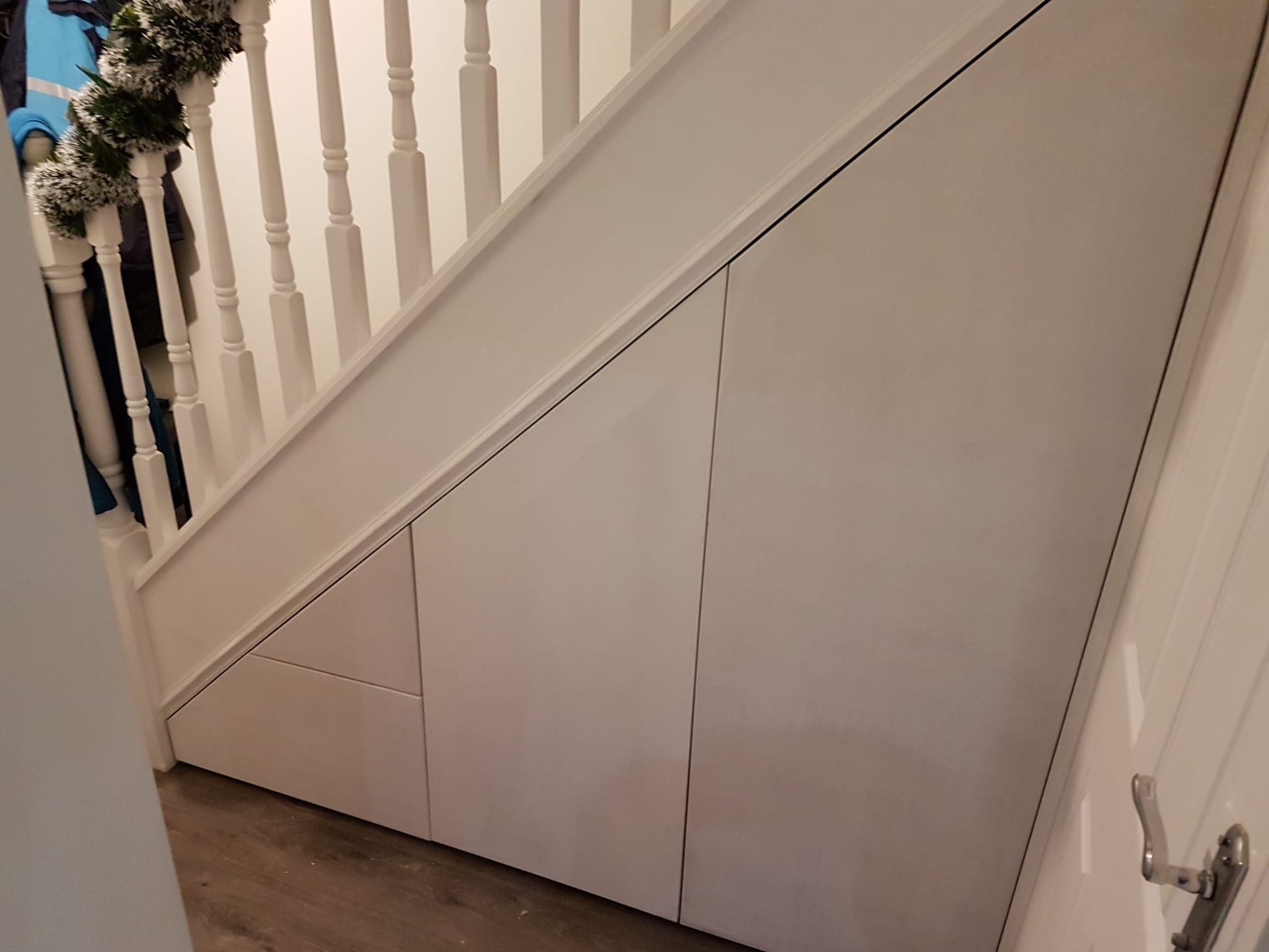 Bespoke under-stairs storage with fitted doors closed